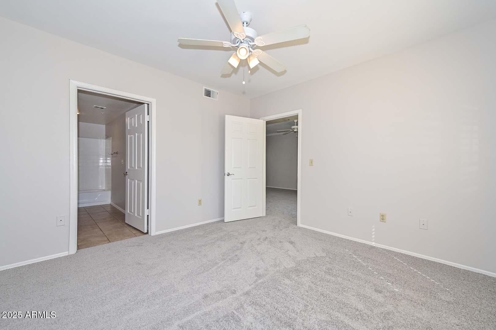 750 East Northern Avenue, Unit 1094 Phoenix, AZ 85020 - Photo 18 of 35 an empty room with fan and a ceiling fan