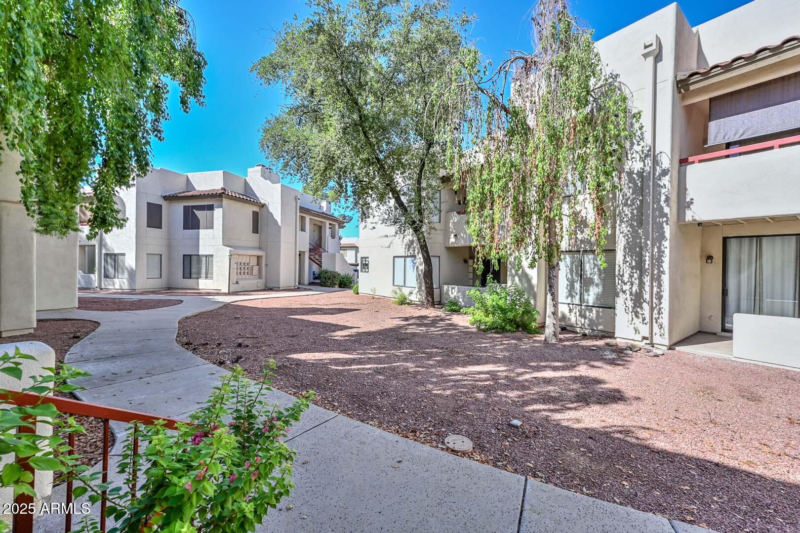 750 East Northern Avenue, Unit 1094 Phoenix, AZ 85020 - Photo 26 of 35 a front view of a house with a yard and garage