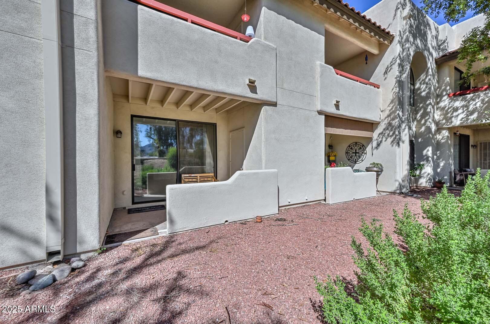 750 East Northern Avenue, Unit 1094 Phoenix, AZ 85020 - Photo 27 of 35 a view of a white house with a yard and sitting area