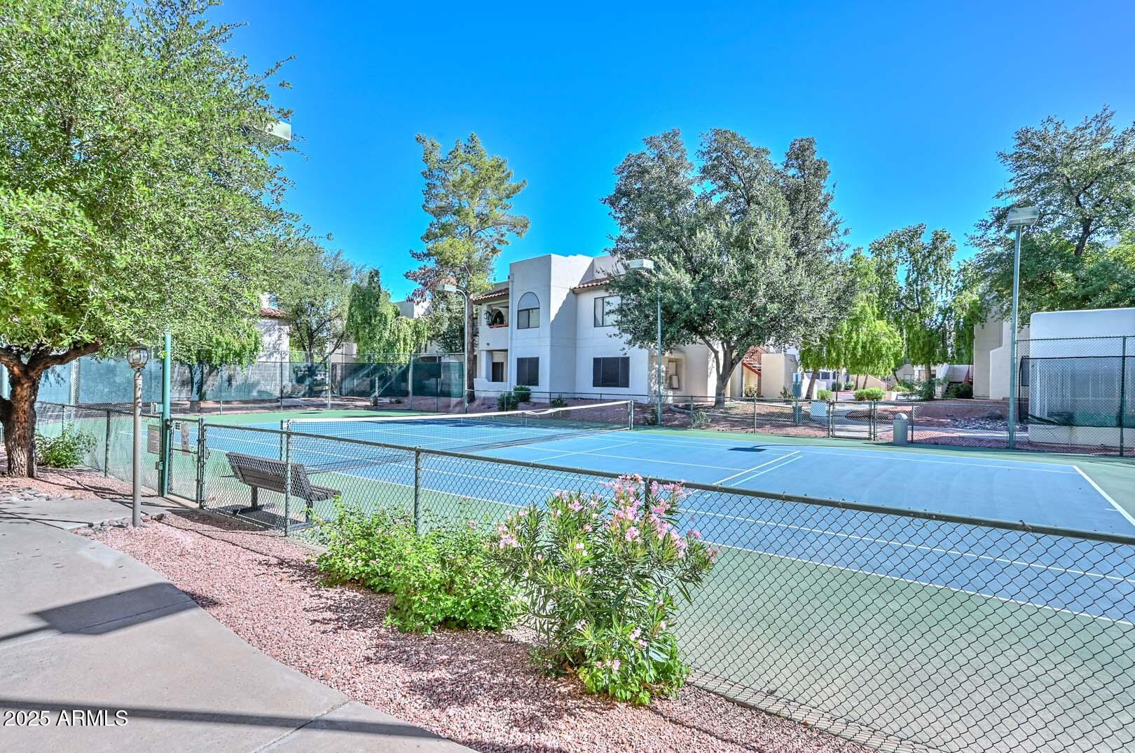 750 East Northern Avenue, Unit 1094 Phoenix, AZ 85020 - Photo 29 of 35 a view of a yard with flower plants and wooden fence