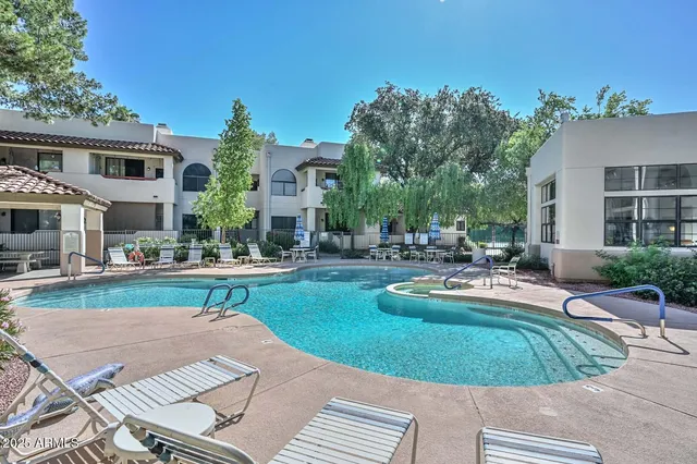 a view of a house with swimming pool and sitting area