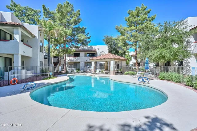 a view of a house with swimming pool and sitting area