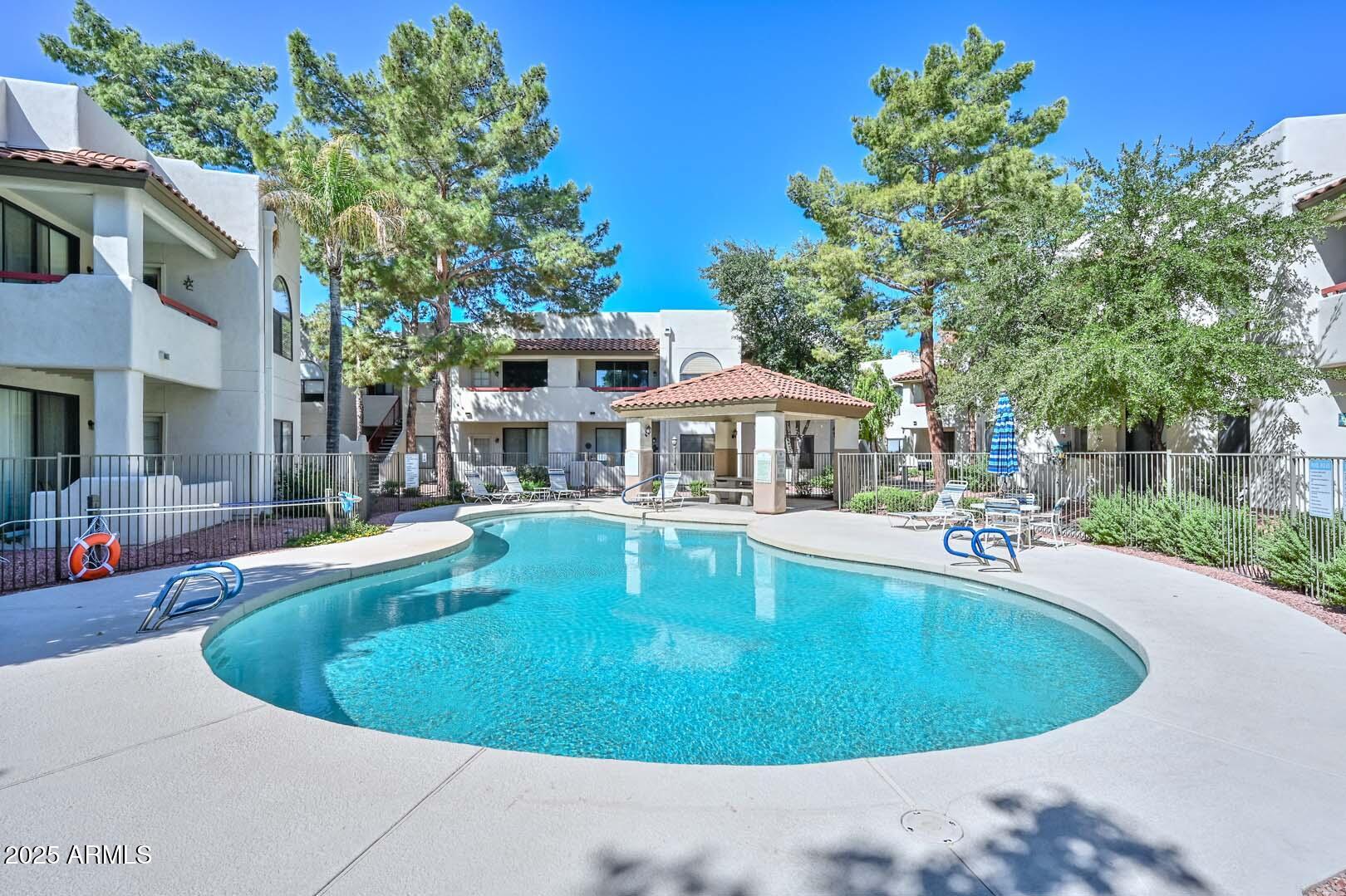 750 East Northern Avenue, Unit 1094 Phoenix, AZ 85020 - Photo 32 of 35 a view of a house with swimming pool and sitting area