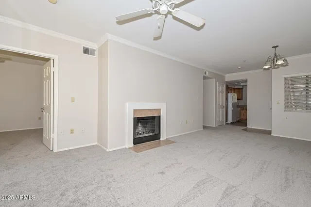 a view of empty room with a fireplace