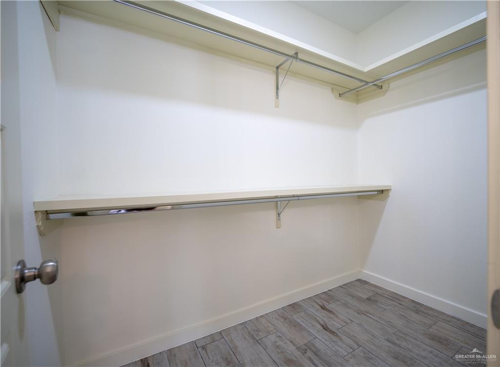 3086 Briggs Road, Unit B Weslaco, TX 78596 - Photo 11 of 15 Walk in closet featuring wood finish floors