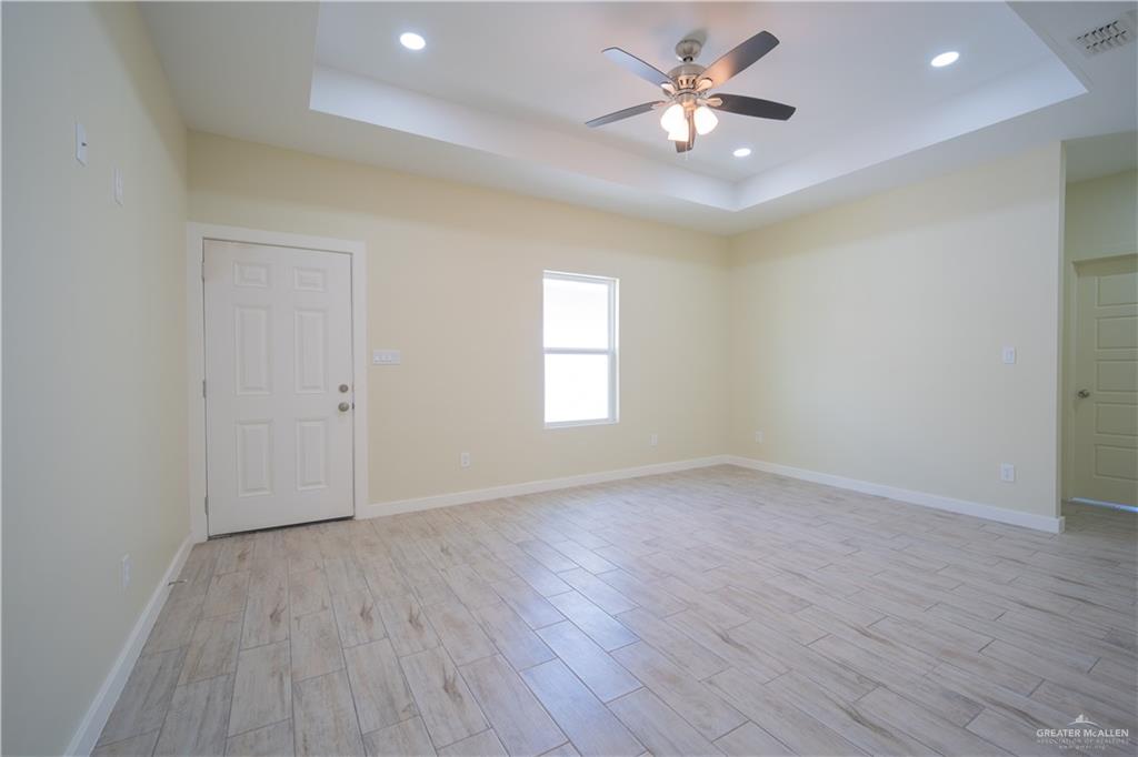 3086 Briggs Road, Unit B Weslaco, TX 78596 - Photo 13 of 15 Unfurnished room featuring wood finish floors, a ceiling fan, and recessed lighting