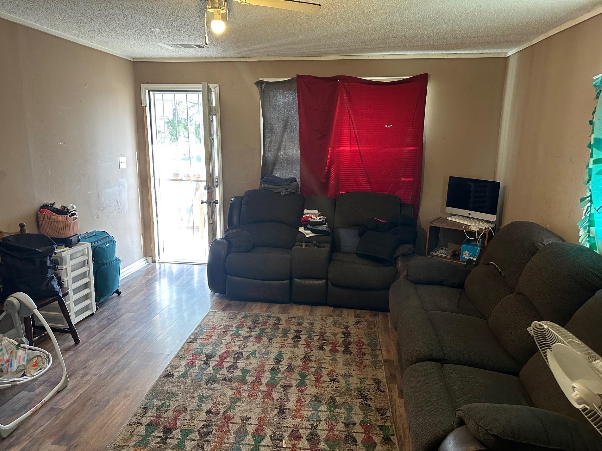 1435 Silver Street Memphis, TN 38106 - Photo 5 of 7 Living area with wood finished floors, a textured ceiling, and ornamental molding