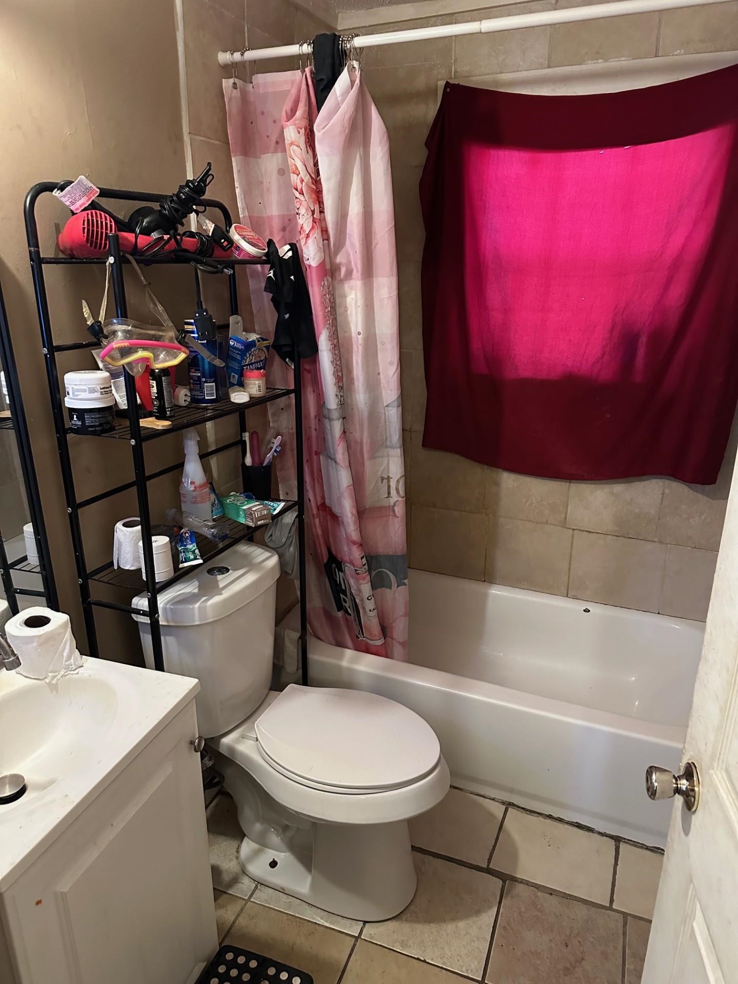 1435 Silver Street Memphis, TN 38106 - Photo 6 of 7 Bathroom with vanity, shower / bathtub combination with curtain, and light tile patterned flooring
