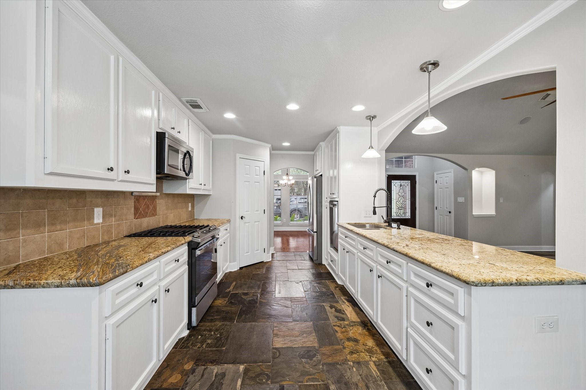 109 Dawns Edge Conroe, TX 77356 - Photo 7 of 24 a large kitchen with kitchen island a sink stainless steel appliances and cabinets