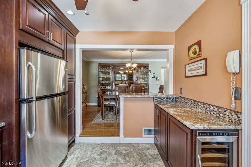 27 Espy Road, Unit A7 Caldwell, NJ 07006 - Photo 9 of 29 a kitchen with granite countertop a refrigerator and a stove