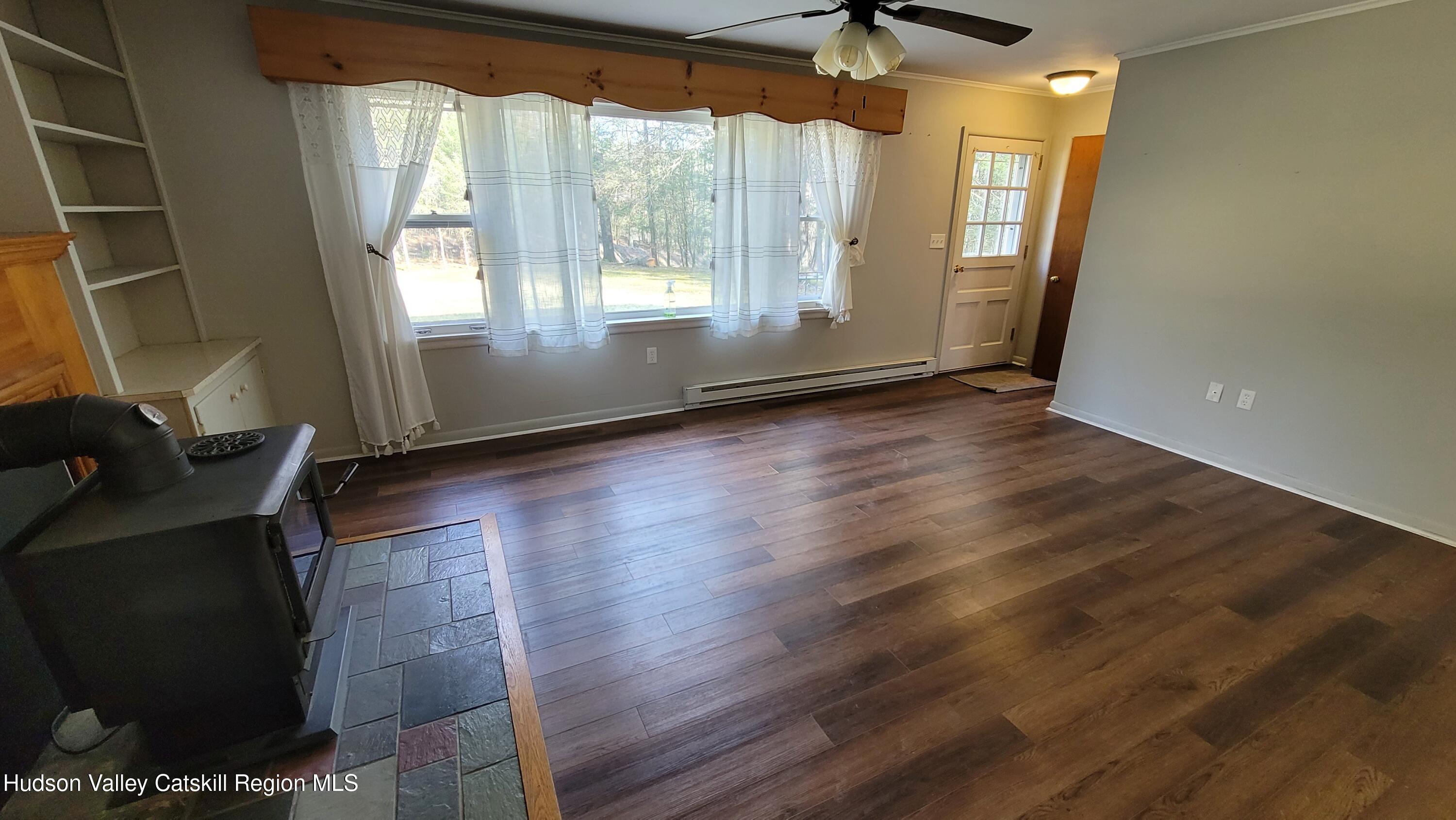 97 Ruby Road Kingston, NY 12401 - Photo 14 of 25 an empty room with wooden floor and windows