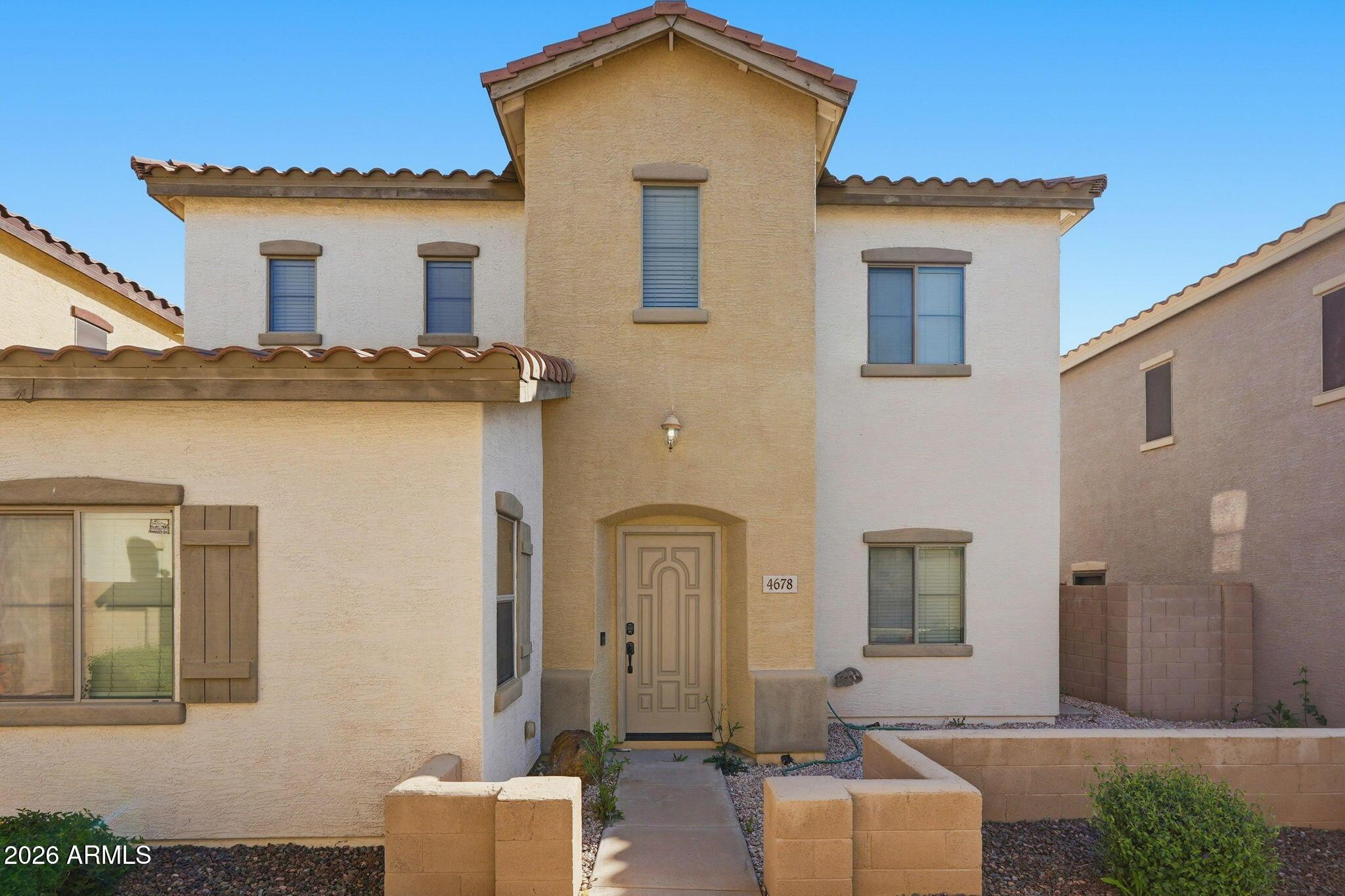 4678 East Redfield Road Gilbert, AZ 85234 - Photo 1 of 31 a front view of a house with a yard