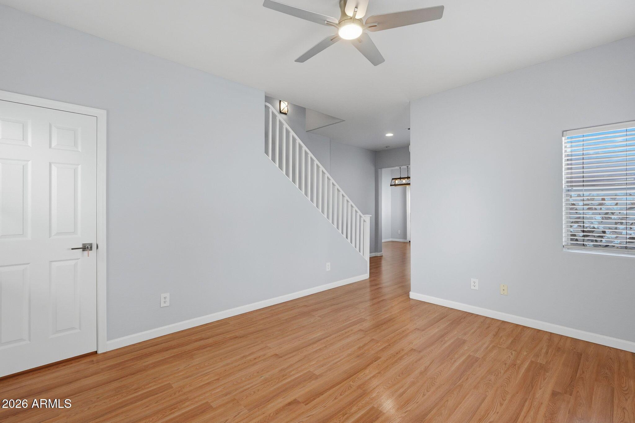 4678 East Redfield Road Gilbert, AZ 85234 - Photo 11 of 31 a view of an empty room with wooden floor and a window