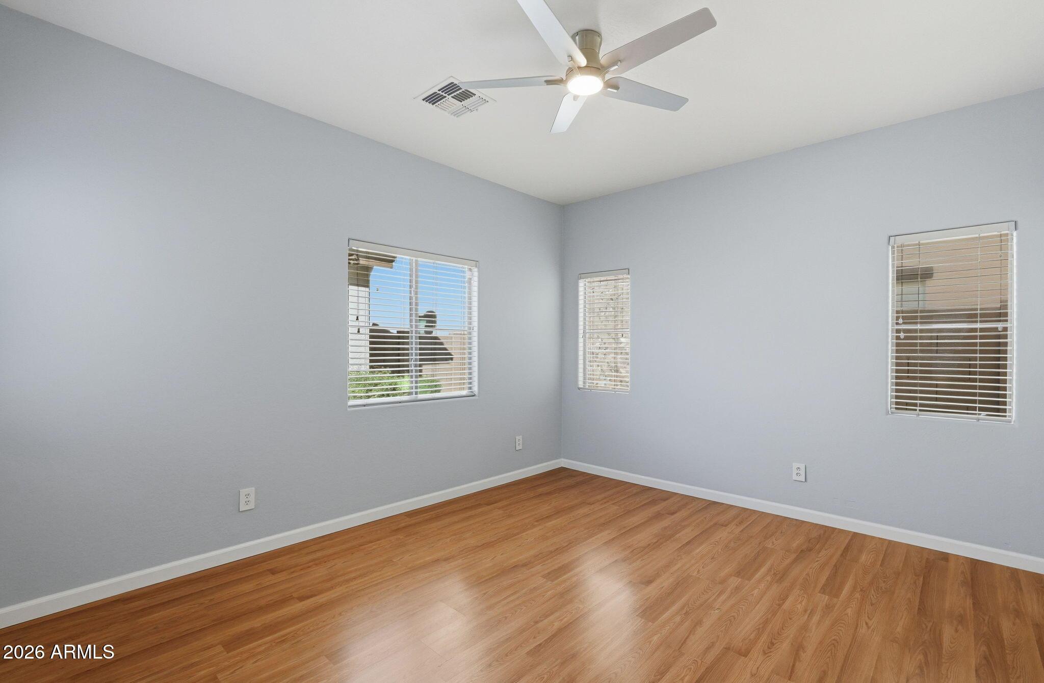 4678 East Redfield Road Gilbert, AZ 85234 - Photo 12 of 31 a view of empty room with wooden floor and fan