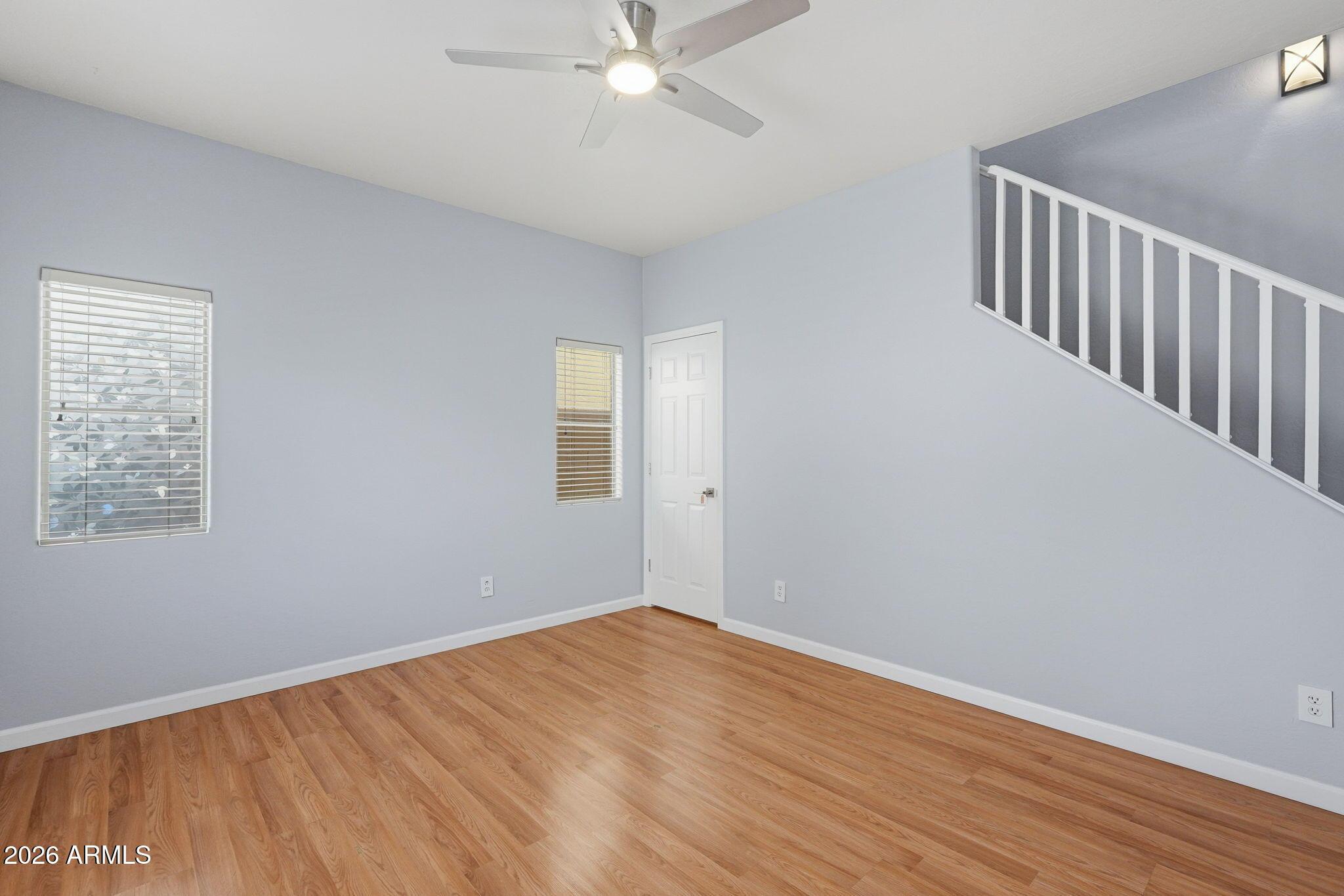 4678 East Redfield Road Gilbert, AZ 85234 - Photo 13 of 31 a view of an empty room with wooden floor and a window
