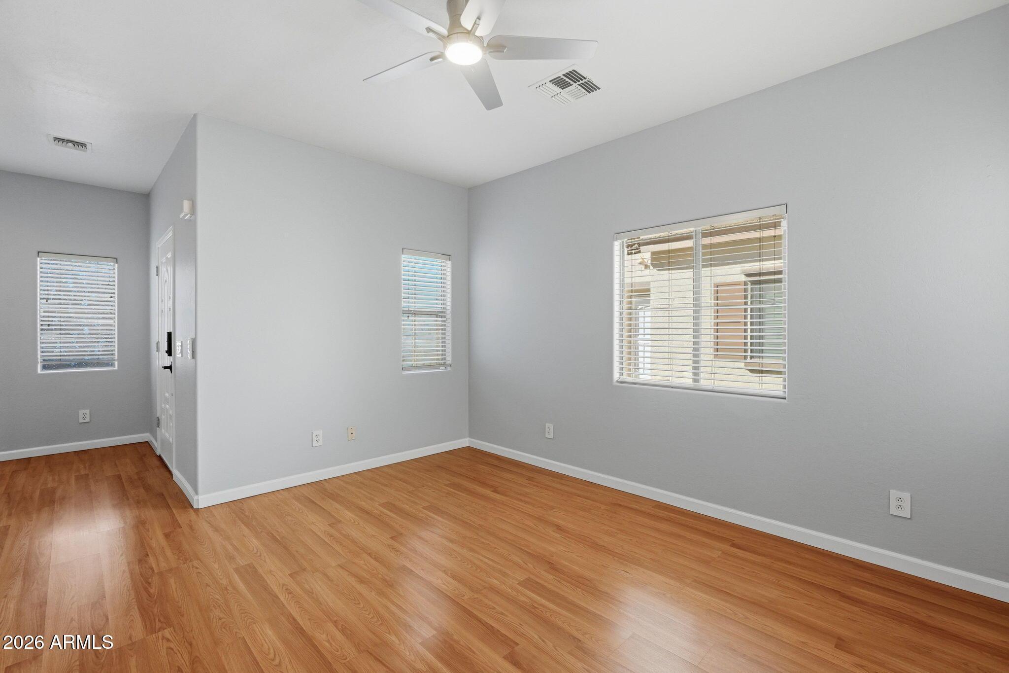 4678 East Redfield Road Gilbert, AZ 85234 - Photo 14 of 31 wooden floor in an empty room with a window