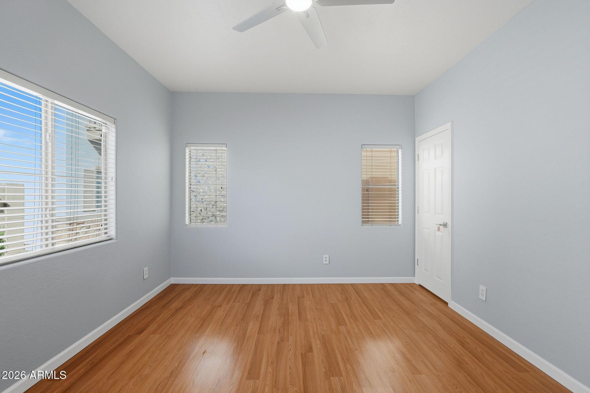 4678 East Redfield Road Gilbert, AZ 85234 - Photo 15 of 31 a view of an empty room with wooden floor and a window