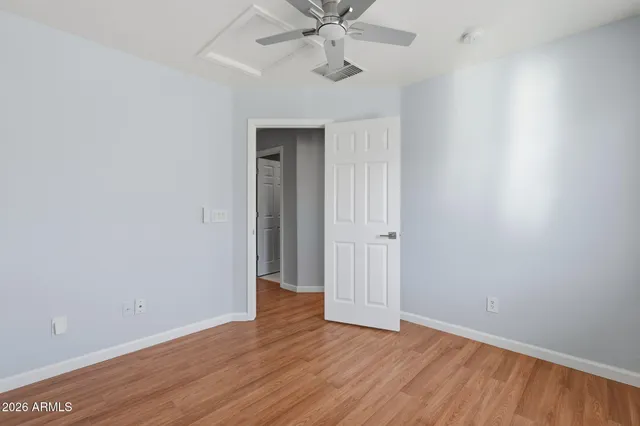 a view of an empty room with wooden floor