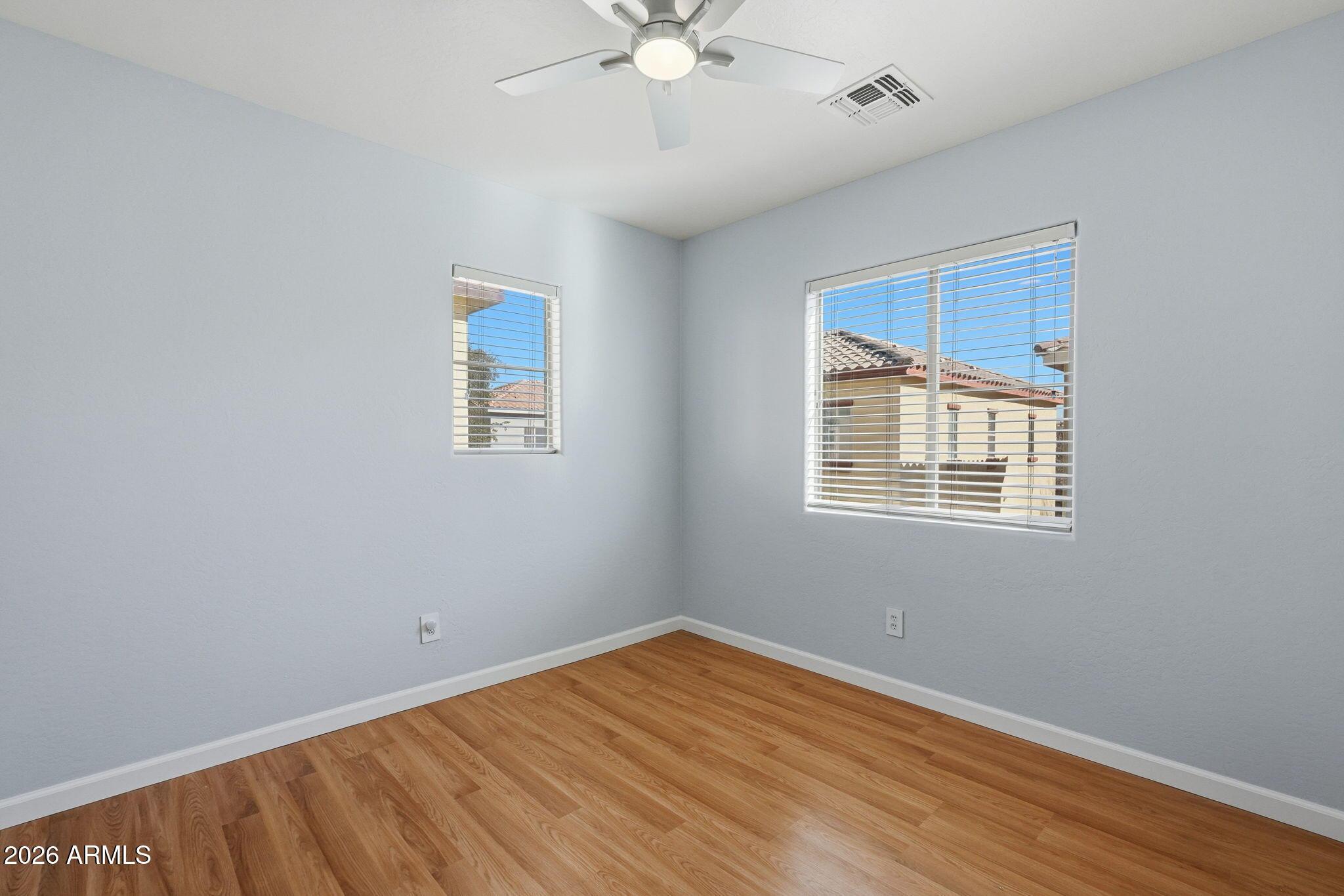 4678 East Redfield Road Gilbert, AZ 85234 - Photo 18 of 31 wooden floor in an empty room with a window