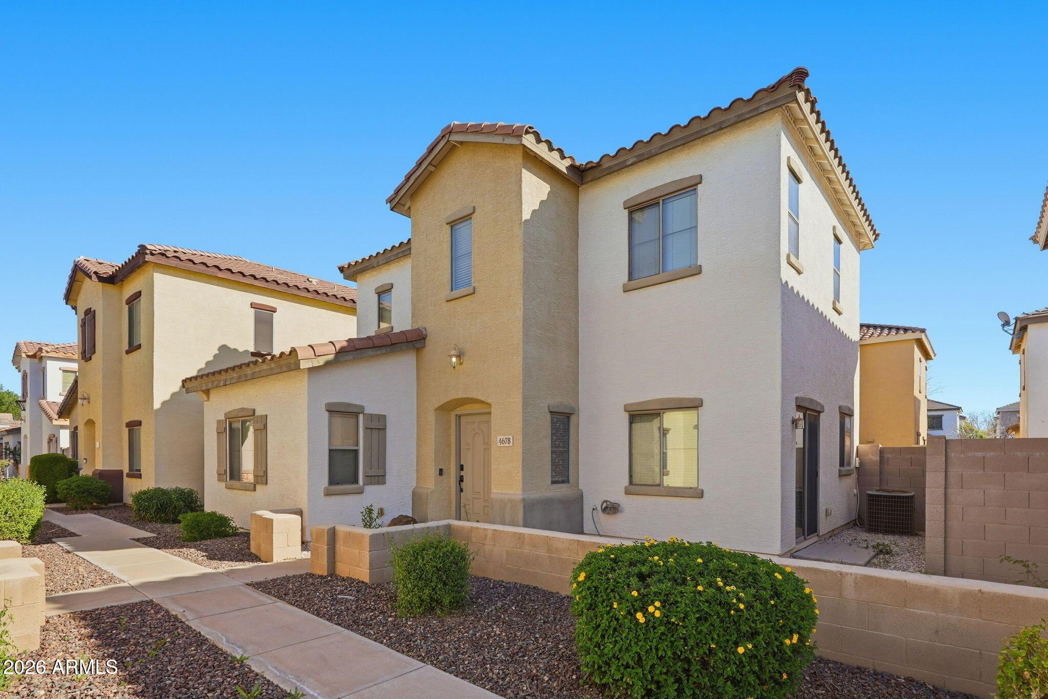 4678 East Redfield Road Gilbert, AZ 85234 - Photo 2 of 31 a front view of a house with garden