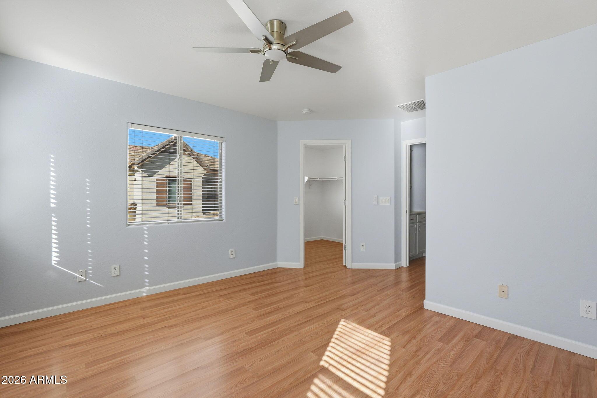 4678 East Redfield Road Gilbert, AZ 85234 - Photo 22 of 31 a view of an empty room with window and wooden floor