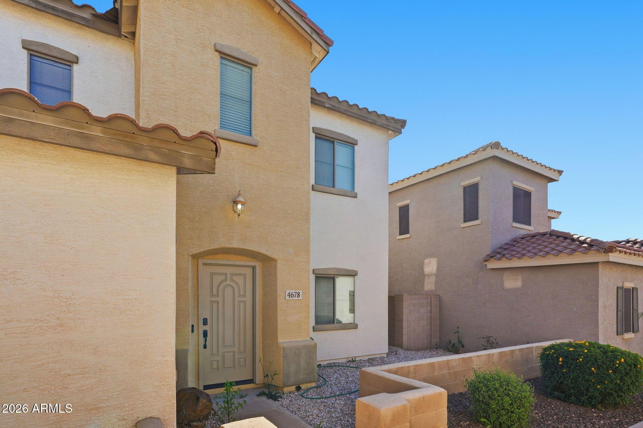 4678 East Redfield Road Gilbert, AZ 85234 - Photo 3 of 31 a front view of a house with parking space