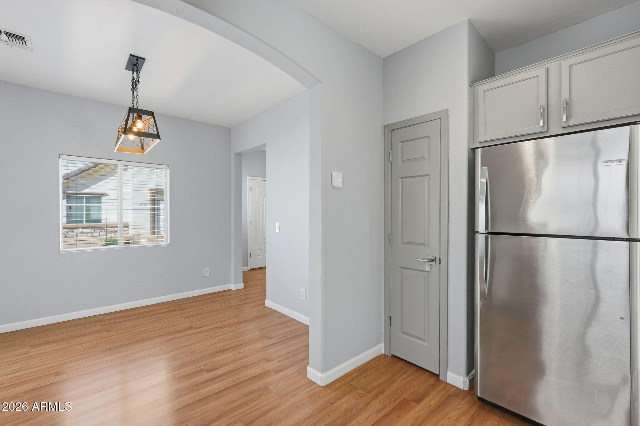 4678 East Redfield Road Gilbert, AZ 85234 - Photo 4 of 31 a kitchen with a refrigerator and wooden floor