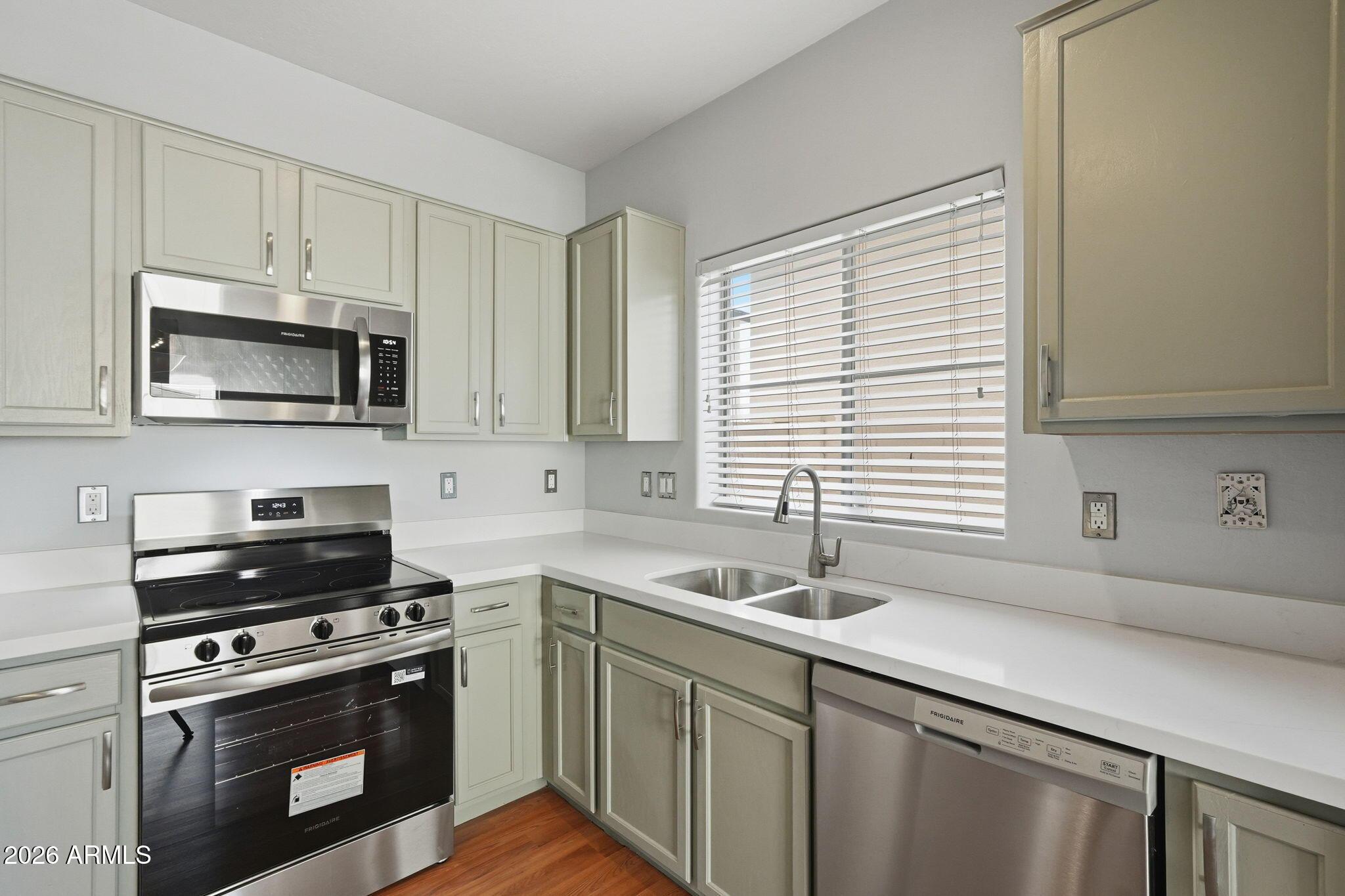 4678 East Redfield Road Gilbert, AZ 85234 - Photo 7 of 31 a kitchen with a sink stove and microwave