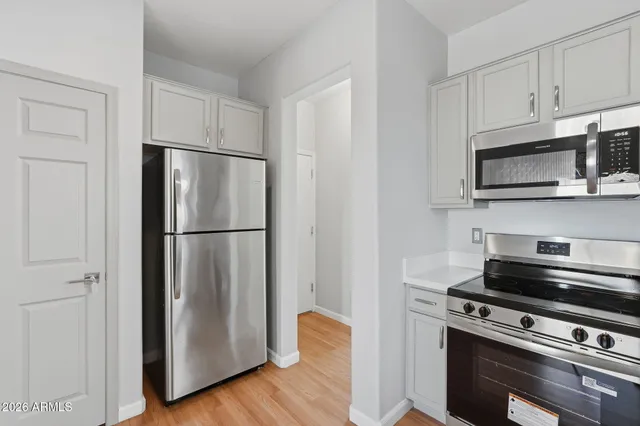 a kitchen with stainless steel appliances a refrigerator microwave and sink