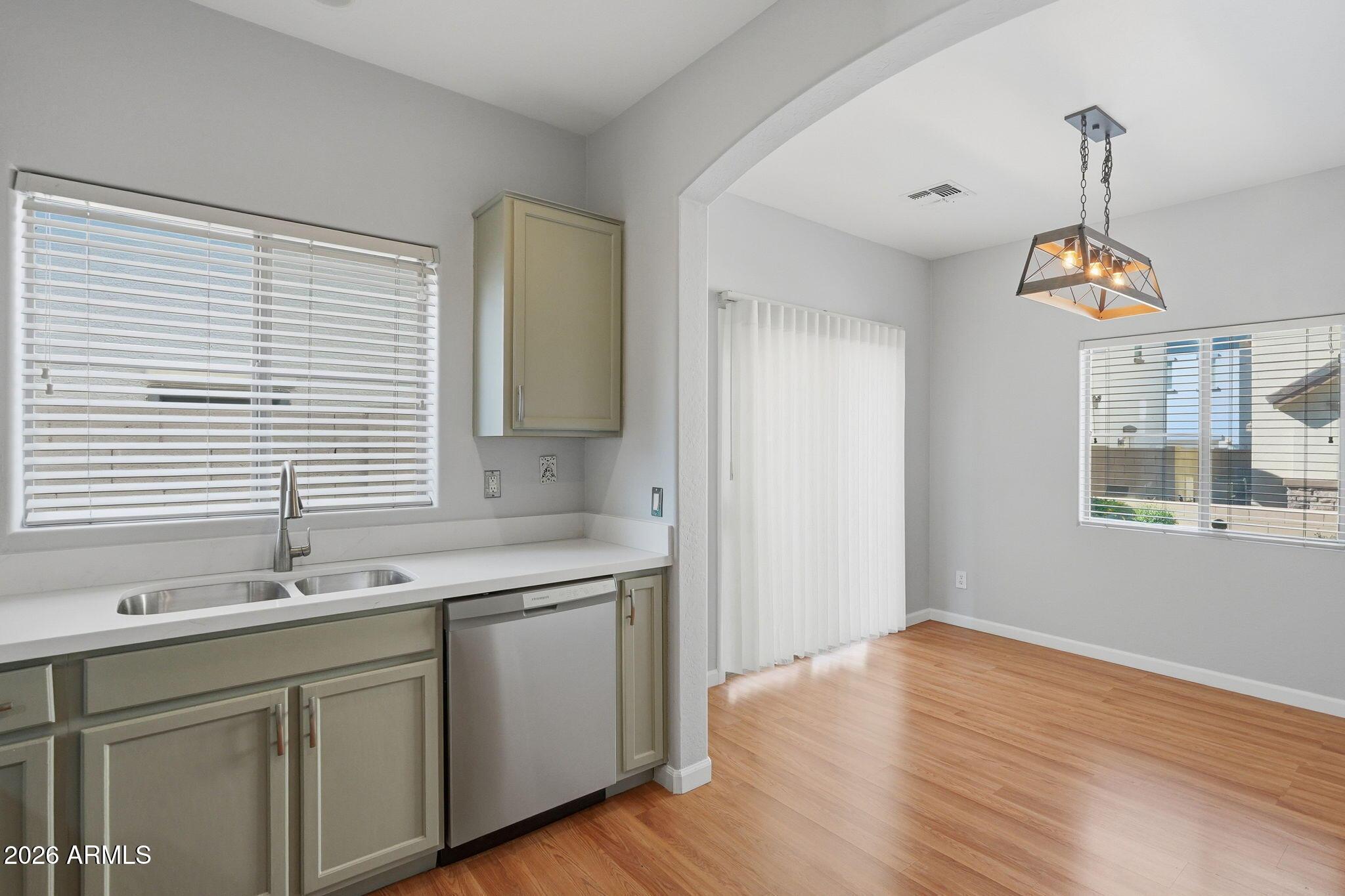 4678 East Redfield Road Gilbert, AZ 85234 - Photo 9 of 31 a kitchen with a sink cabinets and wooden floor