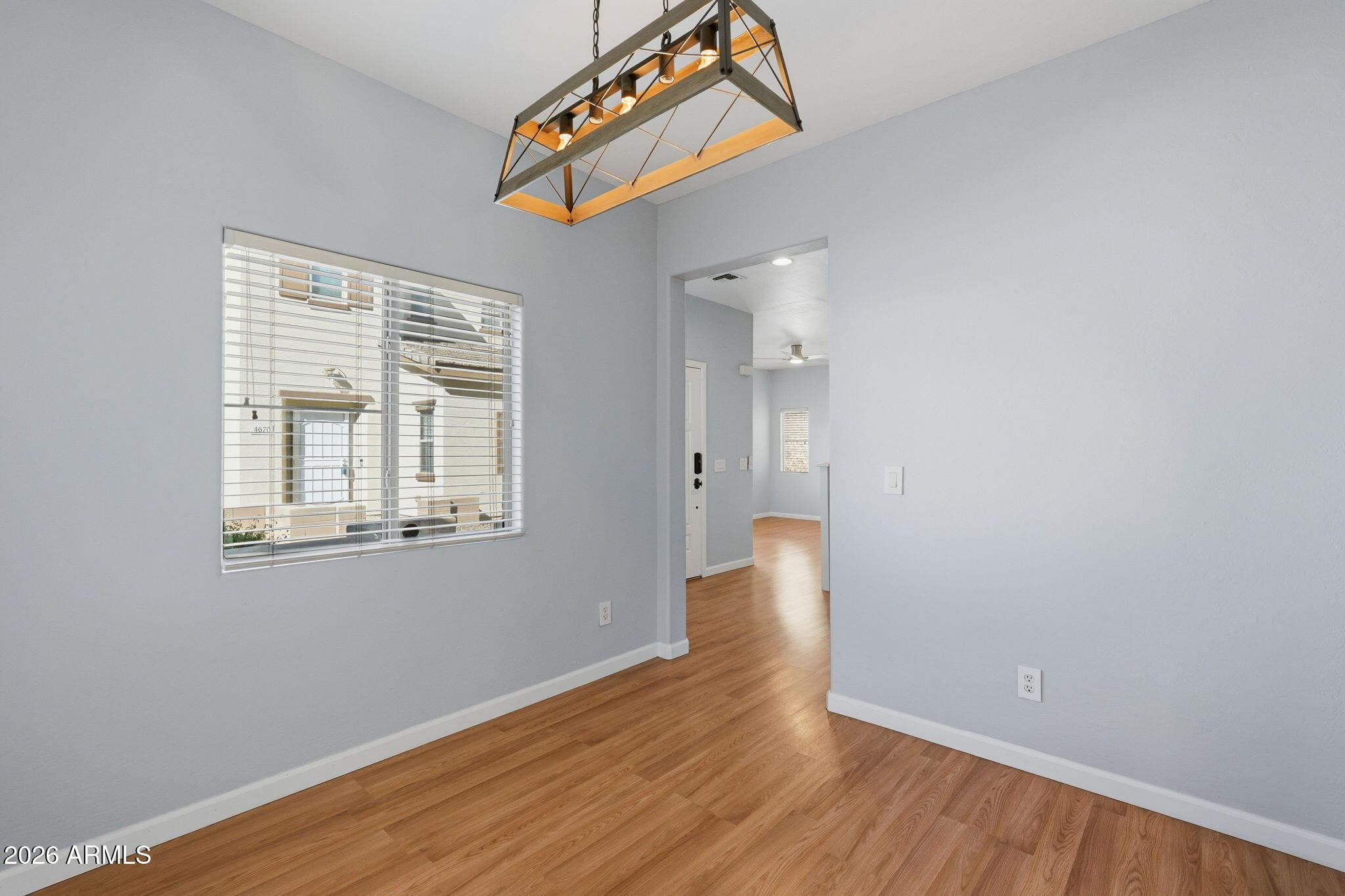 4678 East Redfield Road Gilbert, AZ 85234 - Photo 10 of 31 an empty room with wooden floor and windows