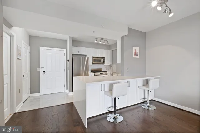 a kitchen with white cabinets
