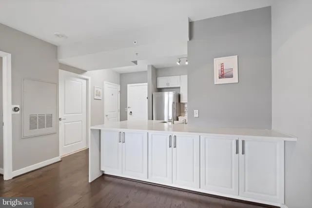 a kitchen with stainless steel appliances kitchen island granite countertop a refrigerator stove and sink