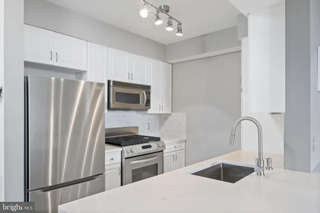 a kitchen with a stove and a sink