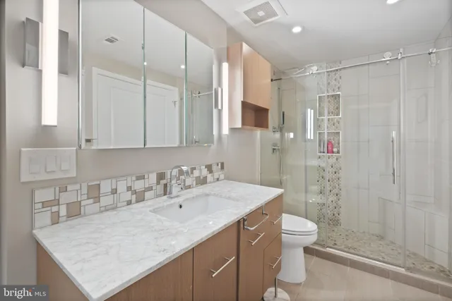 a bathroom with a double vanity sink mirror and shower