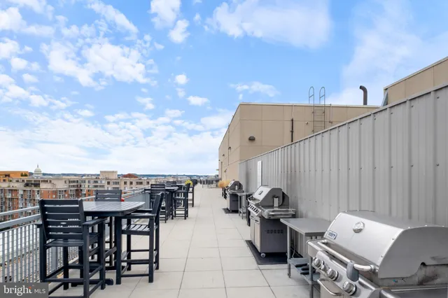 a view of a terrace with furniture and city view