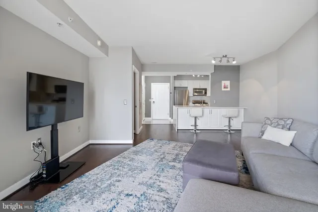 a living room with furniture and view of kitchen