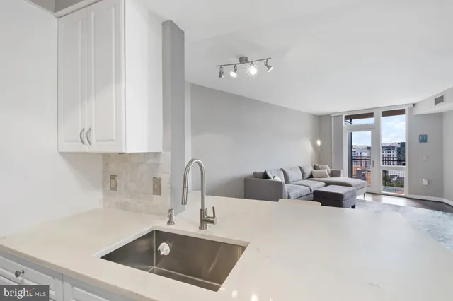 a kitchen with stainless steel appliances a refrigerator and a stove top oven
