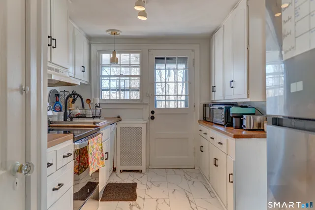 a kitchen with stainless steel appliances a stove a sink and a refrigerator