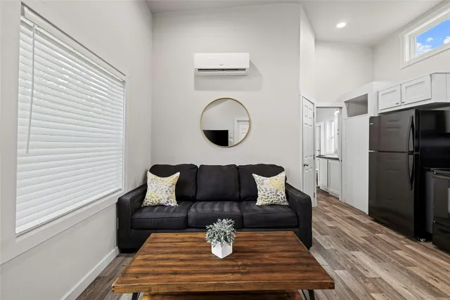 a kitchen with stainless steel appliances granite countertop a sink a stove a dining table and chairs