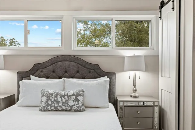 a bedroom with a bed and a painting on the wall