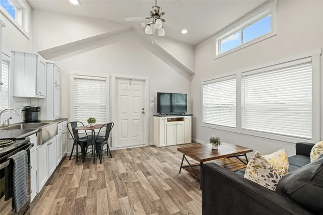 a living room with furniture and a wooden floor