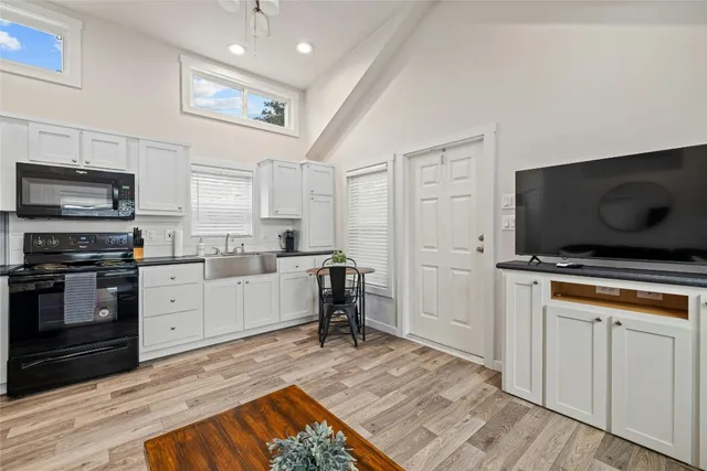 a living room with furniture and kitchen view