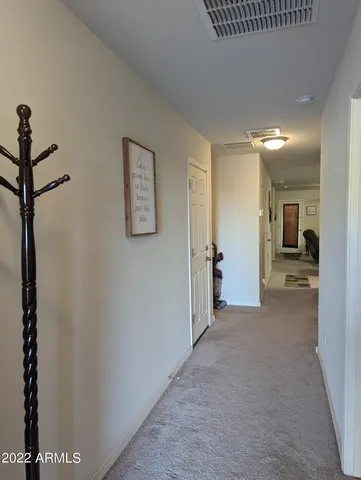 a view of a hallway with bathroom