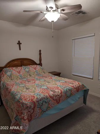 a bed sitting in a bedroom next to a window
