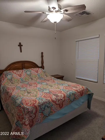 a bed sitting in a bedroom next to a window