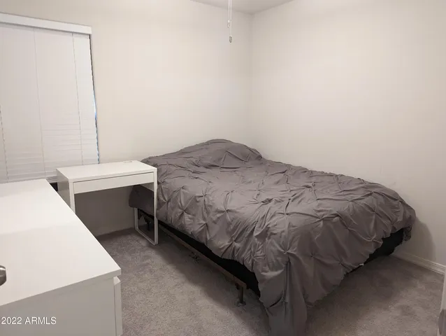 a bedroom with a bed and a table