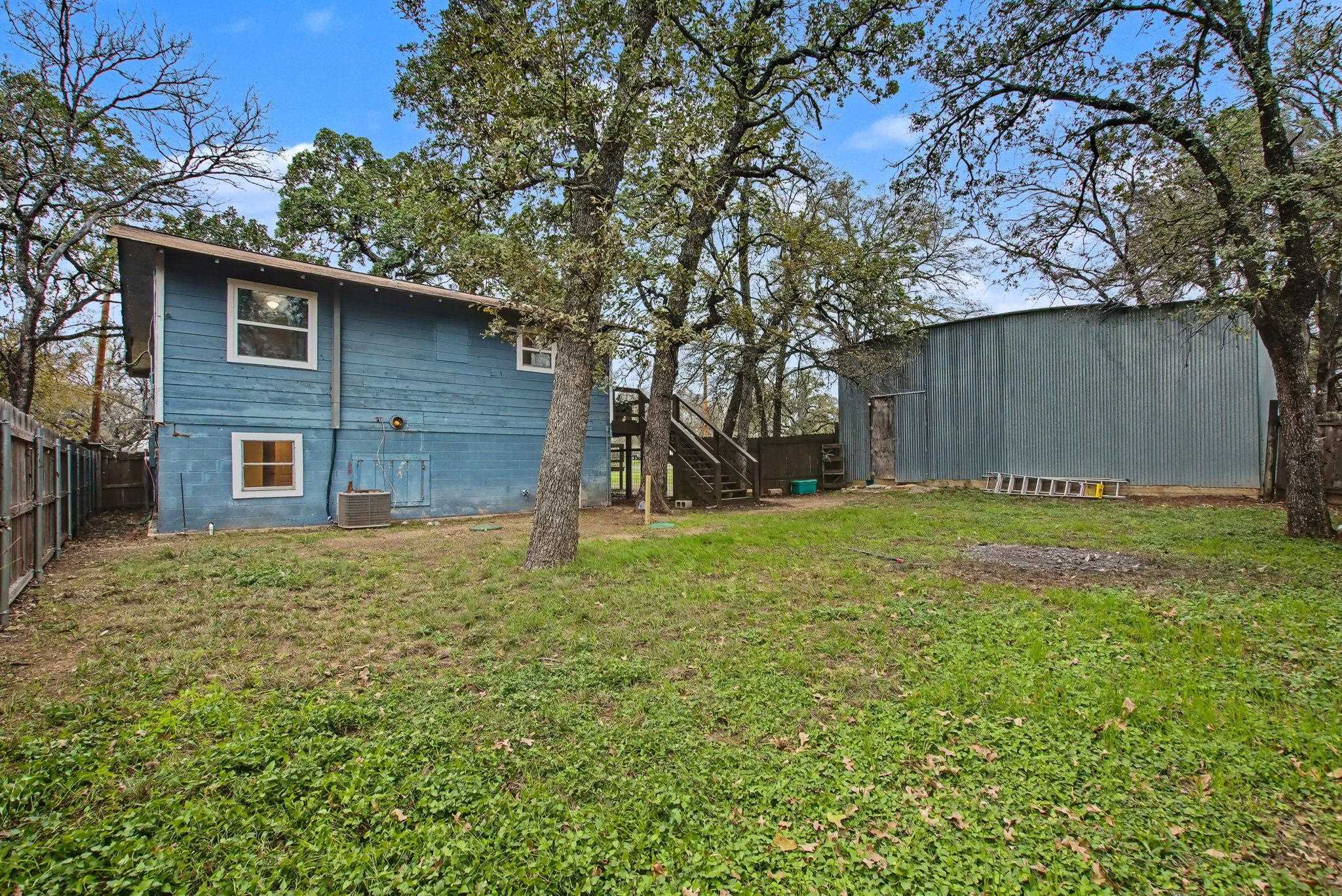 902 Prairie Creek Road Marble Falls, TX 78654 - Photo 6 of 30 a view of a yard in front of a house with a large tree