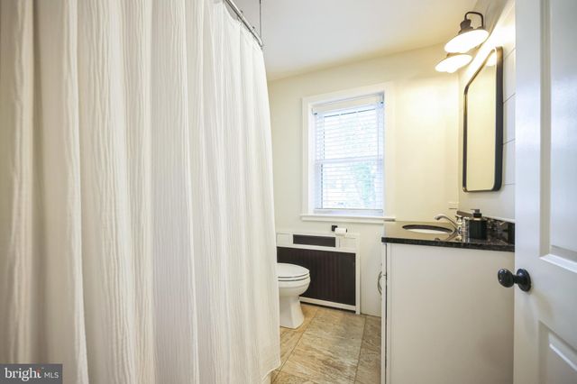 a large bed sitting in a bedroom next to a window