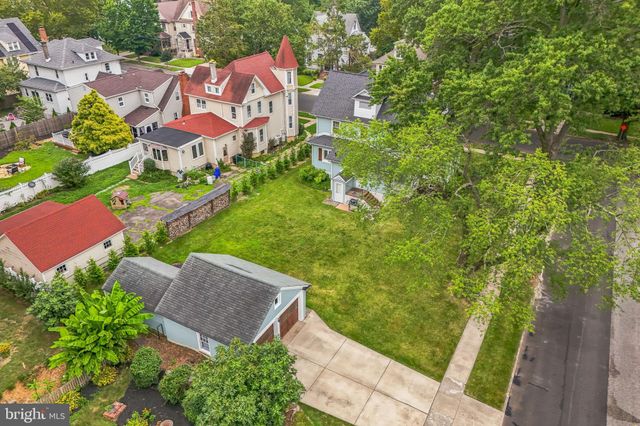 an aerial view of residential houses with outdoor space and street view